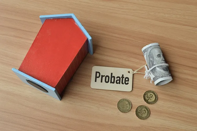 The word probate on a tag next to coins and a toy house.