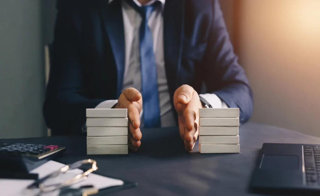 A businessman dividing blocks that implicate assets.